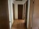 Hallway with multiple doors, light walls, and hardwood flooring at 108 Fair Oaks Se Dr, Conyers, GA 30094