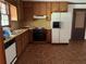Functional kitchen with wooden cabinets, laminate countertops, and essential appliances at 108 Fair Oaks Se Dr, Conyers, GA 30094