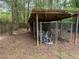 An open storage shed with a chained fence, used for storing items in the backyard at 108 Fair Oaks Se Dr, Conyers, GA 30094