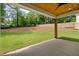 Covered back porch overlooks landscaped backyard with mature trees and lush lawn at 1870 Twin Branch Dr, Marietta, GA 30062