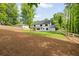 Expansive backyard featuring lush grass, mature trees, and a charming white fenced perimeter at 1870 Twin Branch Dr, Marietta, GA 30062