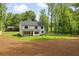 Spacious backyard with lush green lawn, bordered by trees and a white fence, showcasing the home's exterior at 1870 Twin Branch Dr, Marietta, GA 30062