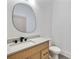 Modern bathroom featuring stylish vanity, quartz counters, black hardware, and unique mirror at 1870 Twin Branch Dr, Marietta, GA 30062