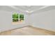 Light and airy bedroom features hardwood floors, tray ceiling, and a large window with backyard view at 1870 Twin Branch Dr, Marietta, GA 30062