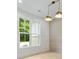 Bright dining room with light wood floors, modern lighting, and a large window with outside views at 1870 Twin Branch Dr, Marietta, GA 30062