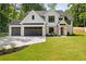 Beautiful two-story home with a three car garage, black framed windows, and fresh landscaping at 1870 Twin Branch Dr, Marietta, GA 30062