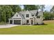 Modern farmhouse with white brick, dark trim, and a three car garage with ample driveway space at 1870 Twin Branch Dr, Marietta, GA 30062