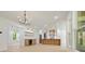 Open floor plan with modern kitchen, stainless steel appliances, and a breakfast bar with designer lighting at 1870 Twin Branch Dr, Marietta, GA 30062