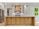 A kitchen island features a white countertop, blond wood cabinetry and is complimented with stainless steel appliances at 1870 Twin Branch Dr, Marietta, GA 30062