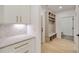 Mudroom with built in bench, cabinets and access to a stylish powder room at 1870 Twin Branch Dr, Marietta, GA 30062
