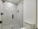 Elegant shower featuring floor-to-ceiling tile, glass doors, and modern fixtures at 1870 Twin Branch Dr, Marietta, GA 30062