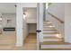 Staircase with wooden handrail, recessed lighting and modern design elements at 1870 Twin Branch Dr, Marietta, GA 30062