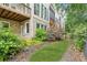 Private backyard includes a patio, lush green lawn, and a path to a wrought iron fence at 5882 Riverstone Cir # 15, Atlanta, GA 30339