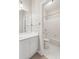 Bright bathroom features a white vanity and a separate tub and shower area with tiled walls at 5882 Riverstone Cir # 15, Atlanta, GA 30339