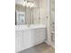 Bright bathroom showcases a large mirror above a white vanity, next to a tiled shower/tub at 5882 Riverstone Cir # 15, Atlanta, GA 30339
