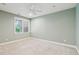 Bedroom featuring carpet, light green walls, a ceiling fan, and ample natural light at 5882 Riverstone Cir # 15, Atlanta, GA 30339