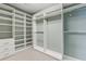 Walk-in closet with custom built-in shelving and drawers for optimal storage at 5882 Riverstone Cir # 15, Atlanta, GA 30339