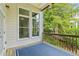 Covered outdoor deck with a view of trees and sunlight spilling in at 5882 Riverstone Cir # 15, Atlanta, GA 30339