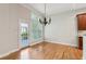 Dining room featuring hardwood floors, modern light fixture, and a view to the backyard at 5882 Riverstone Cir # 15, Atlanta, GA 30339