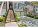 Close-up exterior view of a townhouse featuring brick stairs and a two-car garage, creating a welcoming entrance at 5882 Riverstone Cir # 15, Atlanta, GA 30339