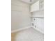 Functional laundry room with tiled floors, built-in shelves, and hookups for washer and dryer at 5882 Riverstone Cir # 15, Atlanta, GA 30339
