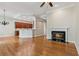 Open-concept living room with hardwood floors, a fireplace, and a view of the kitchen, perfect for Gathering gatherings at 5882 Riverstone Cir # 15, Atlanta, GA 30339