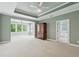 Large main bedroom with sitting area, a tray ceiling, and access to the ensuite bathroom at 5882 Riverstone Cir # 15, Atlanta, GA 30339