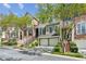 Street view of townhomes with brick and grey stone exterior, plus driveways with two-car garages at 5882 Riverstone Cir # 15, Atlanta, GA 30339