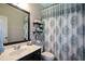 Bathroom featuring a shower and tub combination with decorative shower curtain at 9013 Aldbury Dr, Locust Grove, GA 30248