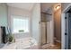 Bright bathroom with a soaking tub and a glass enclosed shower at 9013 Aldbury Dr, Locust Grove, GA 30248