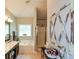 Elegant bathroom featuring a soaking tub, double vanity, and a separate glass-enclosed shower at 9013 Aldbury Dr, Locust Grove, GA 30248