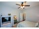 Comfortable bedroom with a ceiling fan and view of the mirror at 9013 Aldbury Dr, Locust Grove, GA 30248