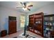 Bedroom with large bookshelves, a TV, and a window offering natural light at 9013 Aldbury Dr, Locust Grove, GA 30248