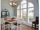 Elegant dining room featuring ample natural light from large arched windows and stylish chandelier at 9013 Aldbury Dr, Locust Grove, GA 30248