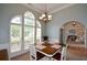 Bright dining room with large arched windows and open access to other living spaces at 9013 Aldbury Dr, Locust Grove, GA 30248