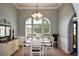 Well-lit dining room with wainscoting and large arched windows overlooking the front yard at 9013 Aldbury Dr, Locust Grove, GA 30248