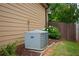 Exterior view of home showing the HVAC unit, well-maintained landscaping, and vinyl siding at 9013 Aldbury Dr, Locust Grove, GA 30248