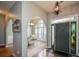 Inviting foyer featuring arched doorways, neutral paint, chandelier and a view into the dining area at 9013 Aldbury Dr, Locust Grove, GA 30248