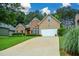 Traditional home with a spacious driveway, brick and siding exterior, manicured landscaping, and a two-car garage at 9013 Aldbury Dr, Locust Grove, GA 30248