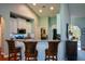 Bright kitchen featuring white cabinets, a breakfast bar with leather stools, and stainless steel appliances at 9013 Aldbury Dr, Locust Grove, GA 30248