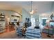 Open-concept living room with vaulted ceilings connecting to the kitchen and dining areas at 9013 Aldbury Dr, Locust Grove, GA 30248