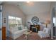 Cozy living room with a large window for natural light, fireplace, and comfortable seating area at 9013 Aldbury Dr, Locust Grove, GA 30248