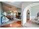 Spacious living room with neutral tones, arched doorways, hardwood floors, and open layout to dining room at 9013 Aldbury Dr, Locust Grove, GA 30248