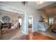 Open-concept living area with hardwood floors, neutral paint, and a view of the fireplace and adjoining bedroom at 9013 Aldbury Dr, Locust Grove, GA 30248