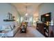 Open living room with vaulted ceilings, neutral colors, fireplace and seamless flow into other spaces at 9013 Aldbury Dr, Locust Grove, GA 30248