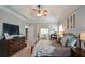 Comfortable main bedroom featuring neutral colors, large dresser and an opening to a seating area at 9013 Aldbury Dr, Locust Grove, GA 30248