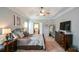 Serene main bedroom featuring a tray ceiling, neutral decor, and an en-suite bathroom at 9013 Aldbury Dr, Locust Grove, GA 30248