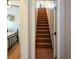 Stairway featuring carpeted stairs and white walls and doorway at 9013 Aldbury Dr, Locust Grove, GA 30248