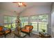Relaxing sunroom filled with natural light, comfortable seating, and views of the backyard at 9013 Aldbury Dr, Locust Grove, GA 30248