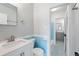 Bright bathroom showcasing blue accent tile and stone vanity with vanity and mirror at 91 Rumson Rd, Atlanta, GA 30305